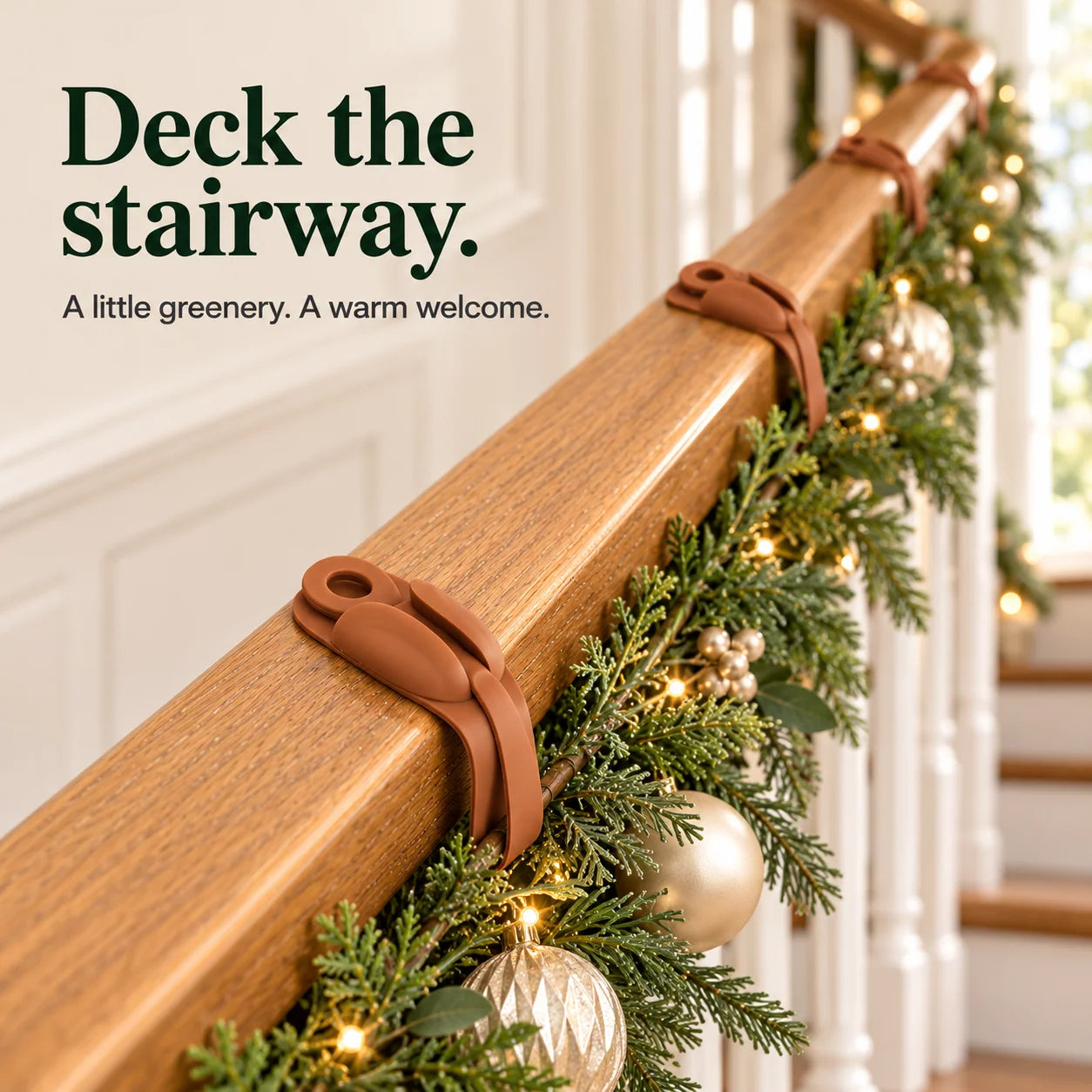 Festive staircase garland held along wooden handrail